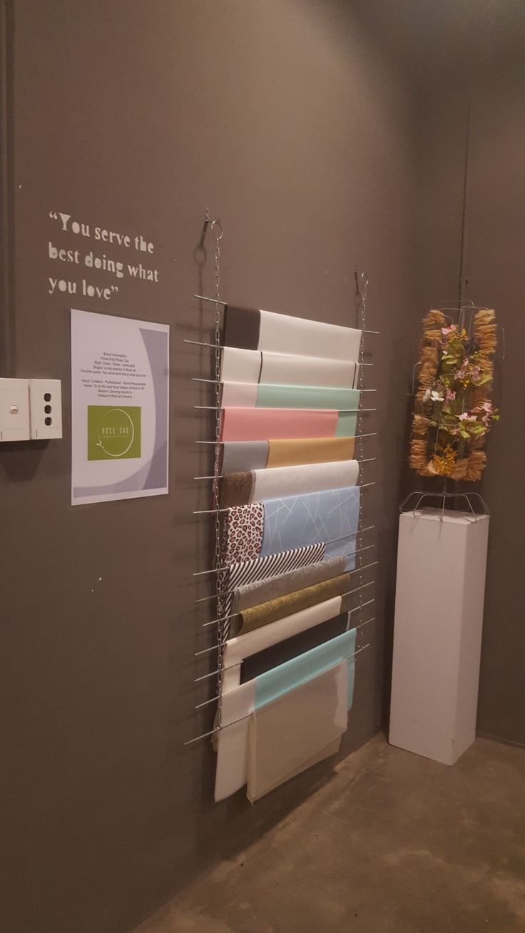 a wall with several different types of fabrics hanging on it's sides and a sign that says, you never see the best deal when you have