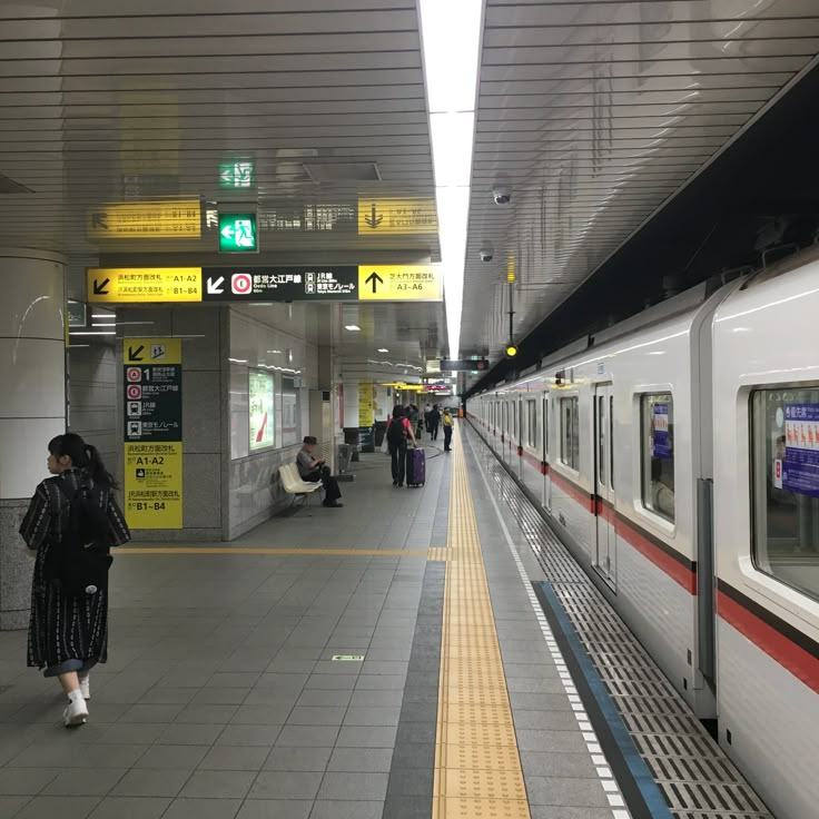 people are waiting for the train to arrive at the subway station in tokyo, japan