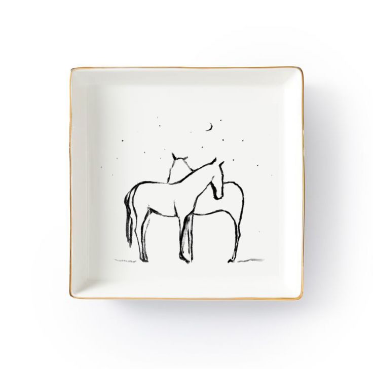 two horses on a white plate with gold trim around the edges and black ink drawing