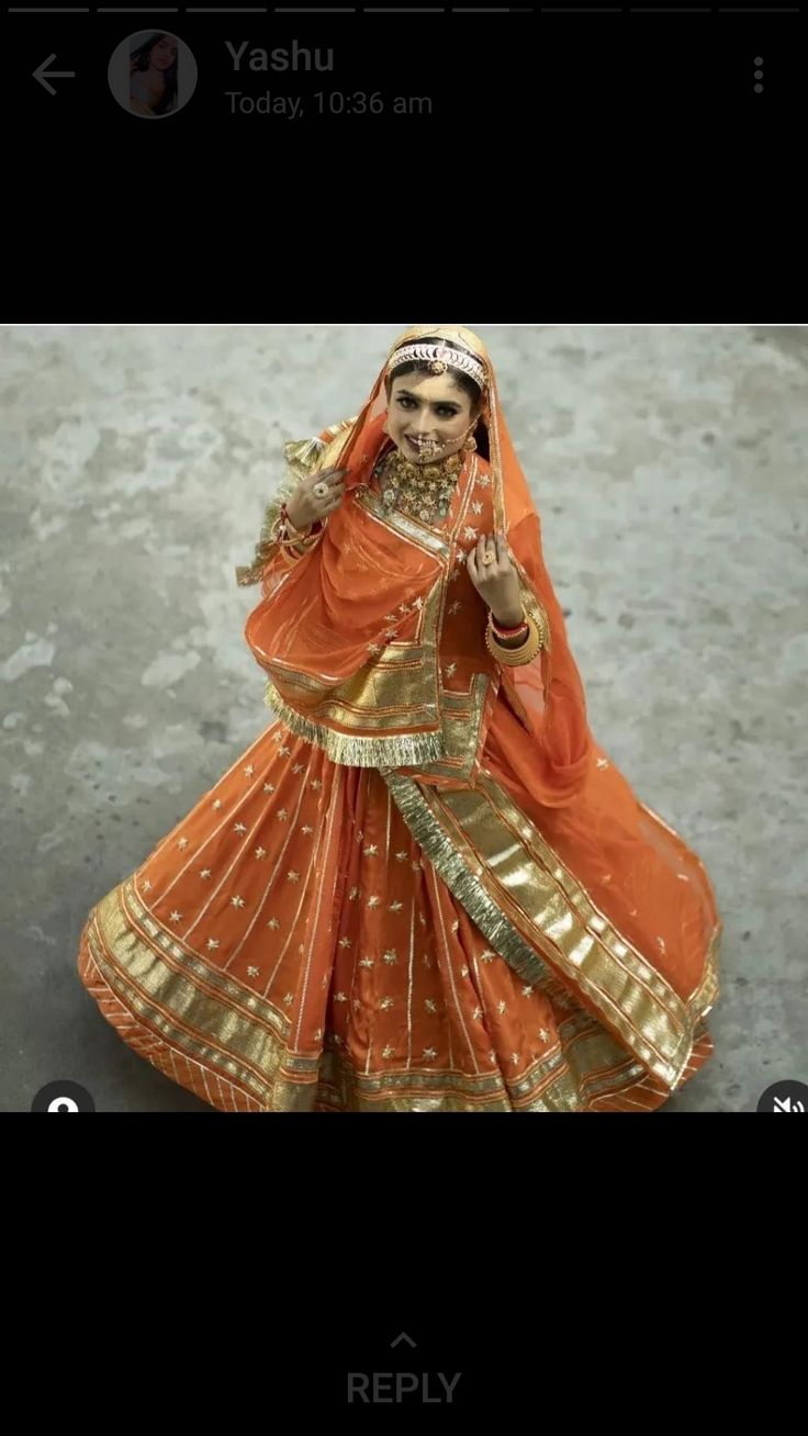 a woman in an orange and gold dress