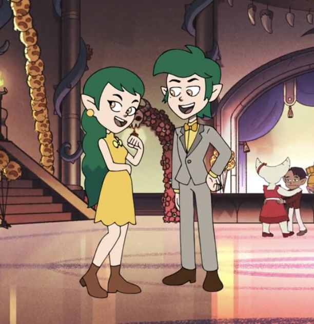 an animated image of two people standing next to each other in front of a stage