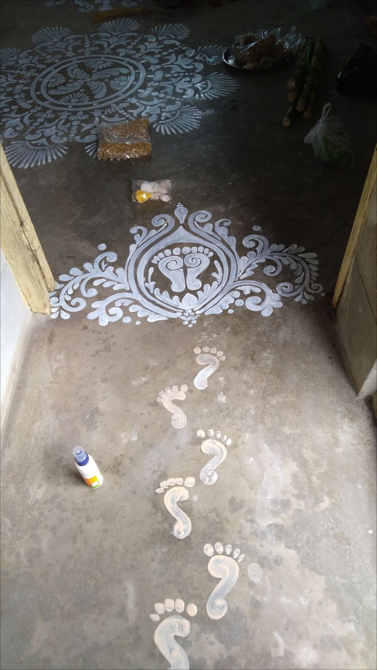 footprints are painted on the ground in front of a door with an animal's foot prints