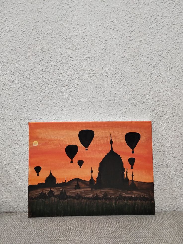 a painting with hot air balloons flying in the sky over a building and trees at sunset