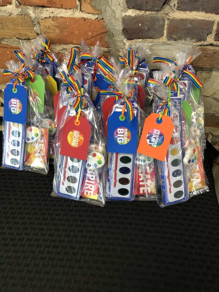 a group of toothbrushes wrapped in plastic and tied with ribbons on top of a table