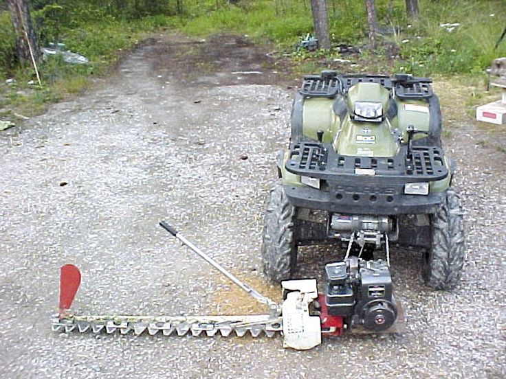 a lawn mower sitting on top of a gravel road