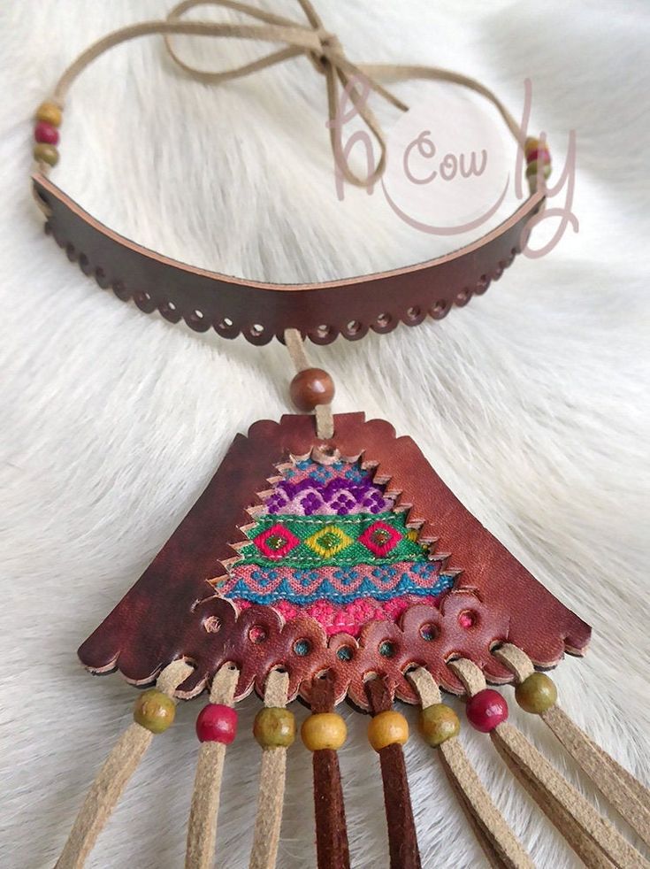 Unleash your bohemian soul with this beautiful one off unique handmade leather necklace. It is made from the finest quality brown leather. The brown leather section of the necklace has vintage hand embroidered Hmong tribal fabric incorporated into it's design. This is not only a necklace it is a piece of art. This long fringe leather choker necklace is adjustable at the back so it fits all sizes. Available in a wide range of colors. Please contact me if you would prefer a different color combina Artisan Embroidered Necklaces For Festivals, Traditional Brown Adjustable Necklace, Traditional Leather Jewelry For Festival, Adjustable Leather Vintage Necklace, Vintage Adjustable Leather Necklace, Hand-stitched Adjustable Bohemian Jewelry, Traditional Handmade Leather Jewelry, Artisan Hand-stitched Festival Jewelry, Traditional Brown Leather Jewelry