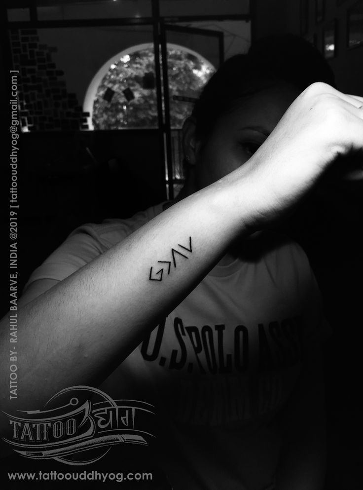 black and white photo of a woman's arm with the word love tattooed on it