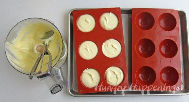 two red trays filled with ice cream next to a blender