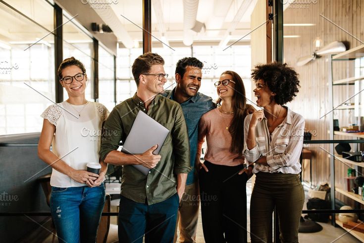 a group of people standing together in an office