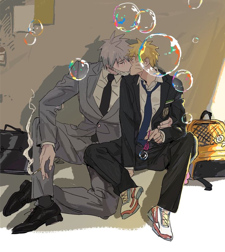 two people sitting on the ground with soap bubbles in front of their faces and one person wearing a suit