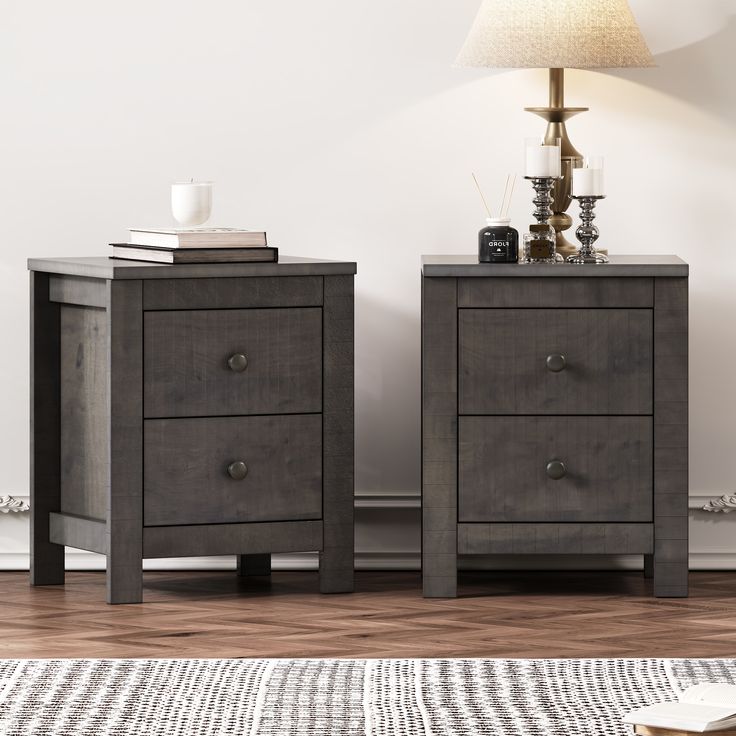 two nightstands sitting next to each other on top of a wooden floor in front of a white wall