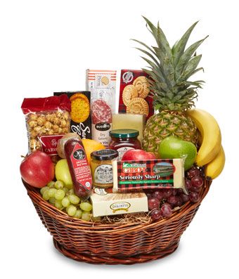 a wicker basket filled with wine, cheese and fruit