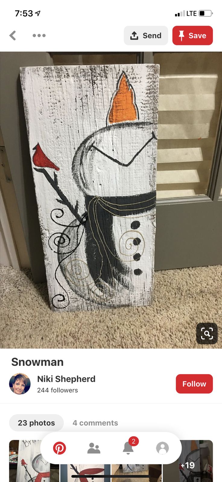 a wooden sign with a snowman painted on it