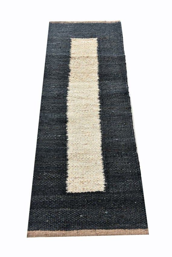 a black and white rug with a stripe on it