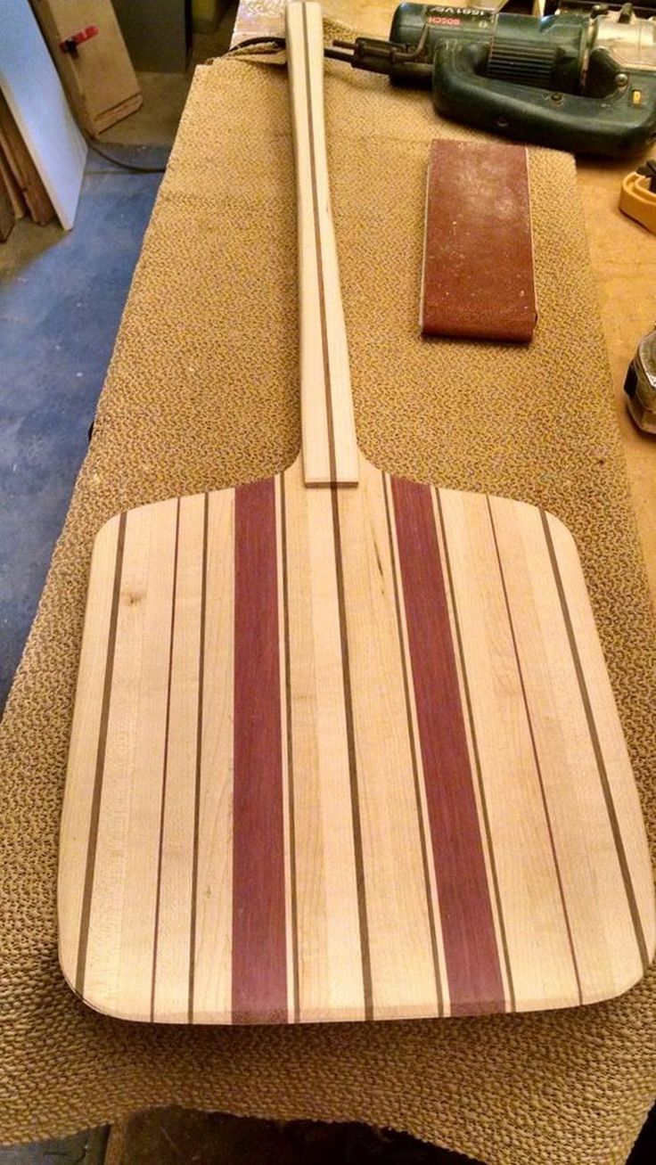 a wooden guitar sitting on top of a table