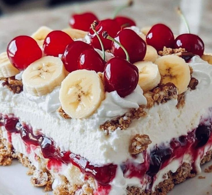 a piece of cake with bananas and cherries on top