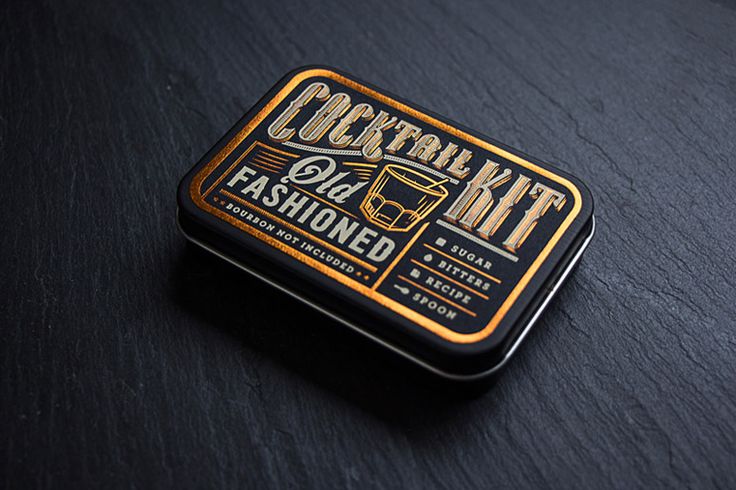 a black and gold tin with an image of a cocktail kit on it