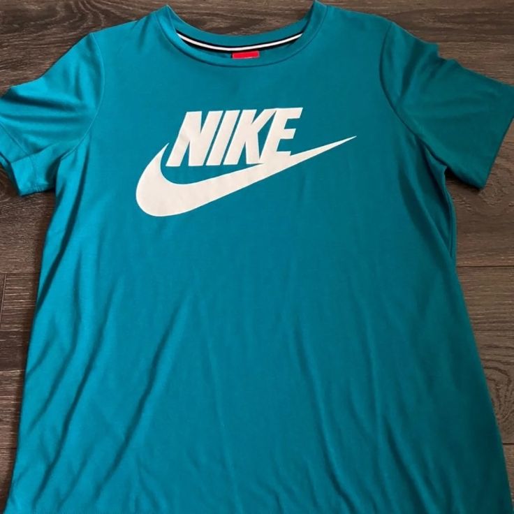 Teal Nike Tshirt Never Worn Unisex Nike Green T-shirt With Graphic Print, Green Nike Crew Neck T-shirt, Blue Crew Neck Top With Logo Print, Basic Blue Tops With Graphic Print, Nike Blue Top With Logo Print, Nike Green Tops With Logo Print, Nike Green Top With Logo Print, Nike Blue Tops With Logo Print, Nike Green Short Sleeve T-shirt