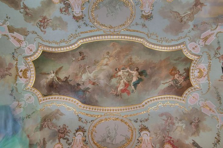 an ornate painted ceiling with paintings on it