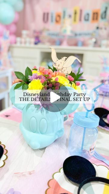 the disneyland birthday party is set up with mickey ears and flowers in blue vases