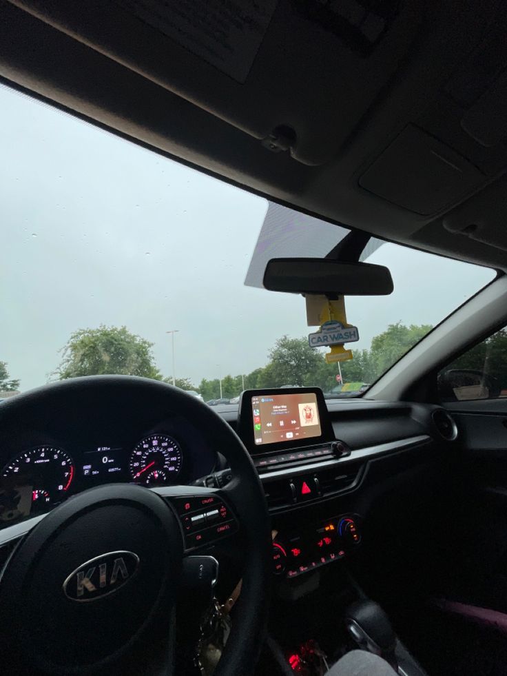 the interior of a car with dashboard, dash lights and steering wheel view from driver's seat