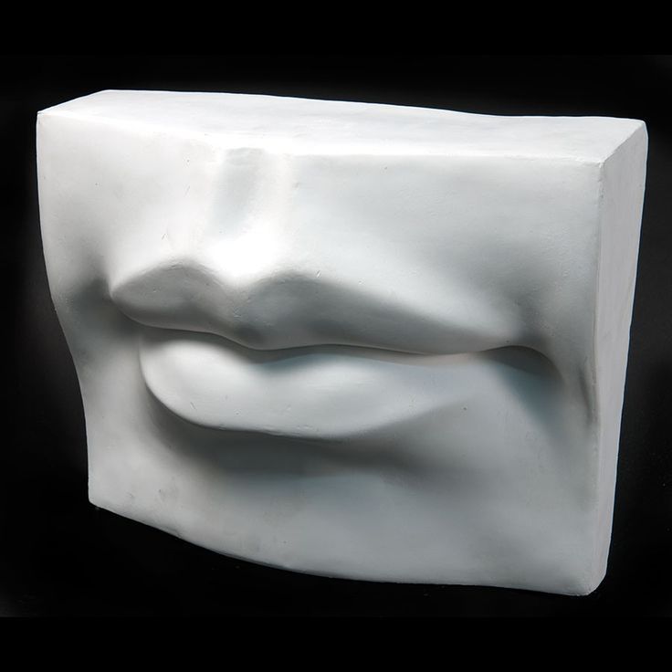 a white sculpture sitting on top of a black surface