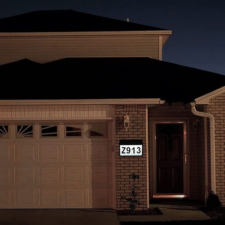 a house is lit up at night with the number 2913 on it's front door