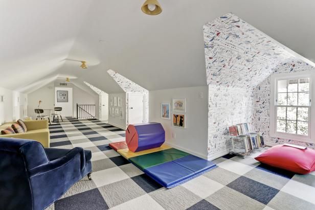 a living room with checkered flooring and colorful furniture in the middle of it