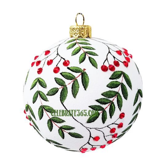 a white ornament with red berries and green leaves