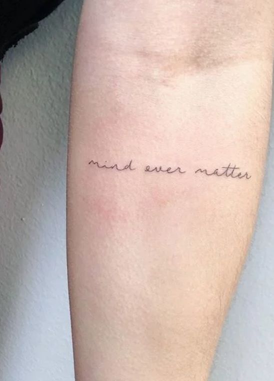 a person with a tattoo on their arm that says, and ever matter in cursive writing