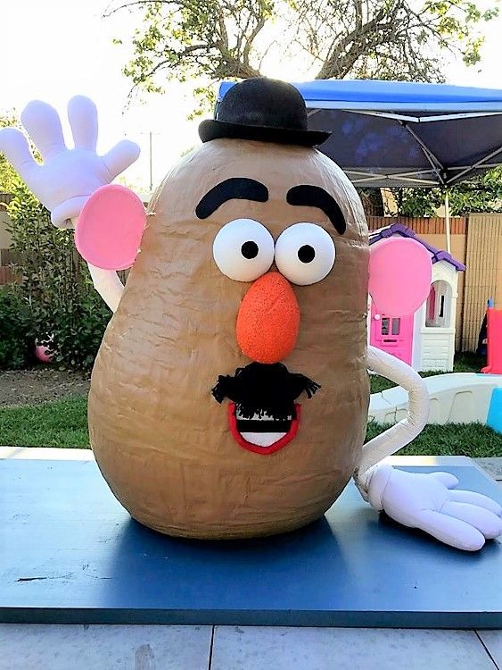 a giant potato head sitting on top of a blue table