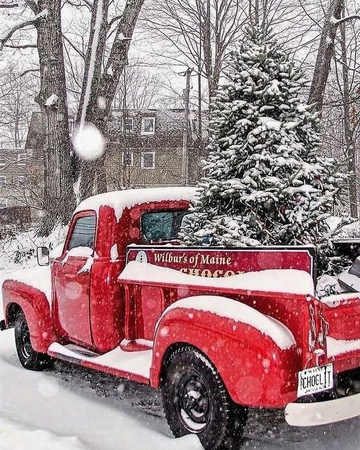 an old red truck parked in front of a tree covered in snow with the words winter of maine written on it