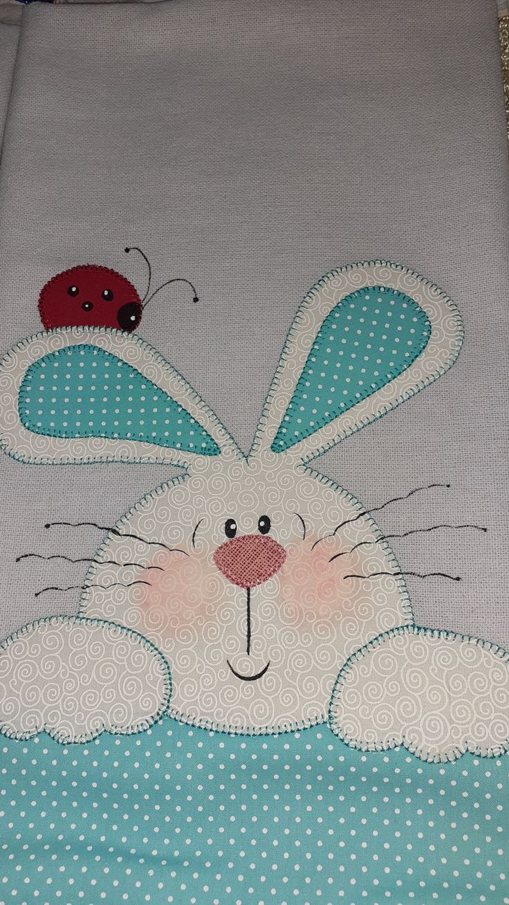 a white bunny rabbit with ladybugs on it's back