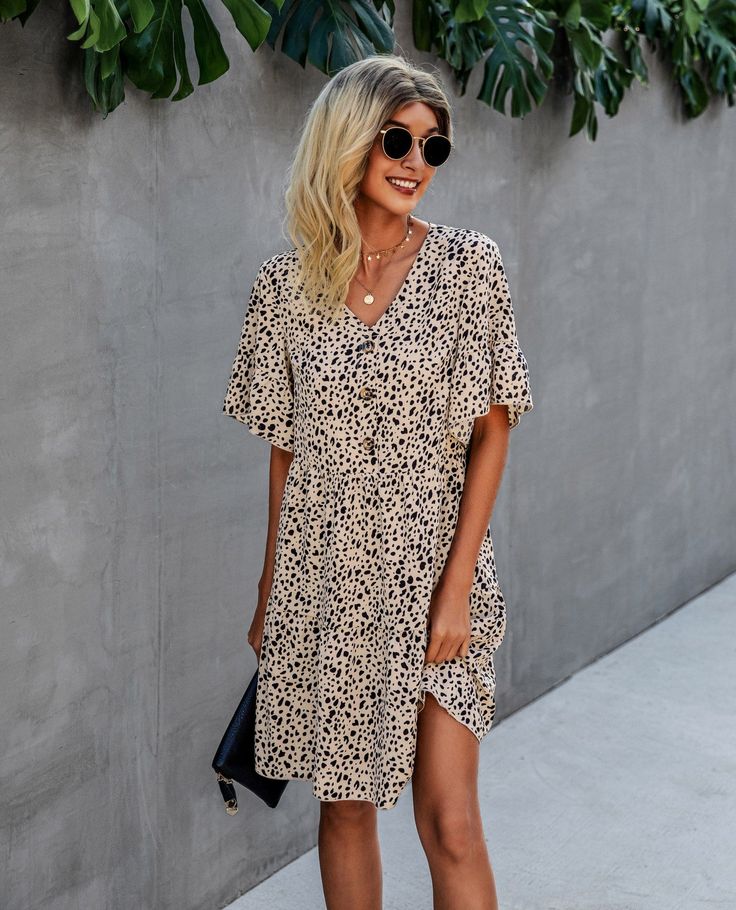 The EMES SHOP dress is detailed with a bold contrast button design. Features a v neck line. animal prints. short ruffle sleeves. flowy skirt. and above knee length. Pair it with sunnies and sandals for a chic summer look.MATERIAL:100% Soft Poly MEASUREMENTS:Dress Length is 36"-39"in Small | Bust& Waist: 36"-38"in Medium | Bust& Waist: 38"-40"in Large | Bust& Waist: 40"-42"in X Large | Bust& Waist: 42"-44"in Chic Leopard Print Mini Dress For Beach, Leopard Print V-neck Beach Dress, Leopard Print Mini Dress For Vacation, Casual Leopard Print Mini Dress For Vacation, Casual Leopard Print Mini Dress For Beach, Chic Leopard Print V-neck Mini Dress, Leopard Print Mini Dress For Beach, Casual Leopard Print Summer Dress, Casual Leopard Print Dress For Day Out