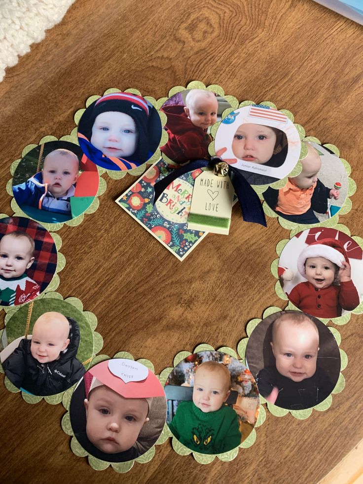 a wooden table topped with pictures of babies