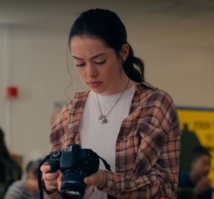 a woman holding a camera in her hands