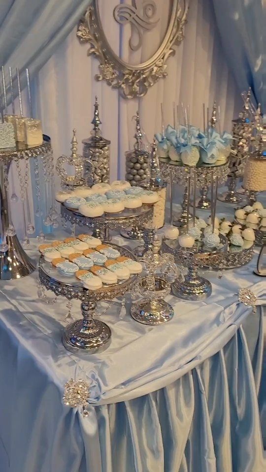 a table topped with lots of desserts and cupcakes on top of it