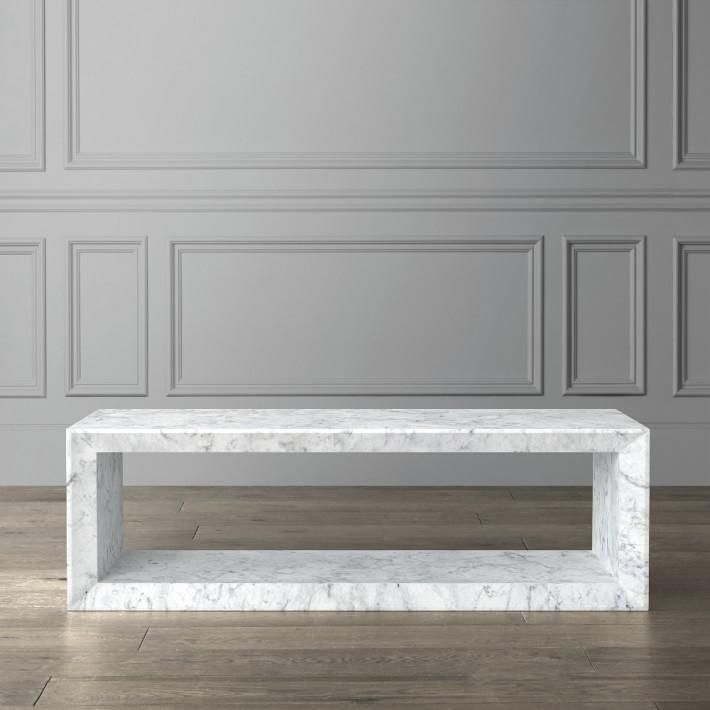 a white marble coffee table in an empty room