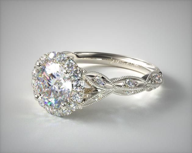 a white gold engagement ring with an oval cut diamond