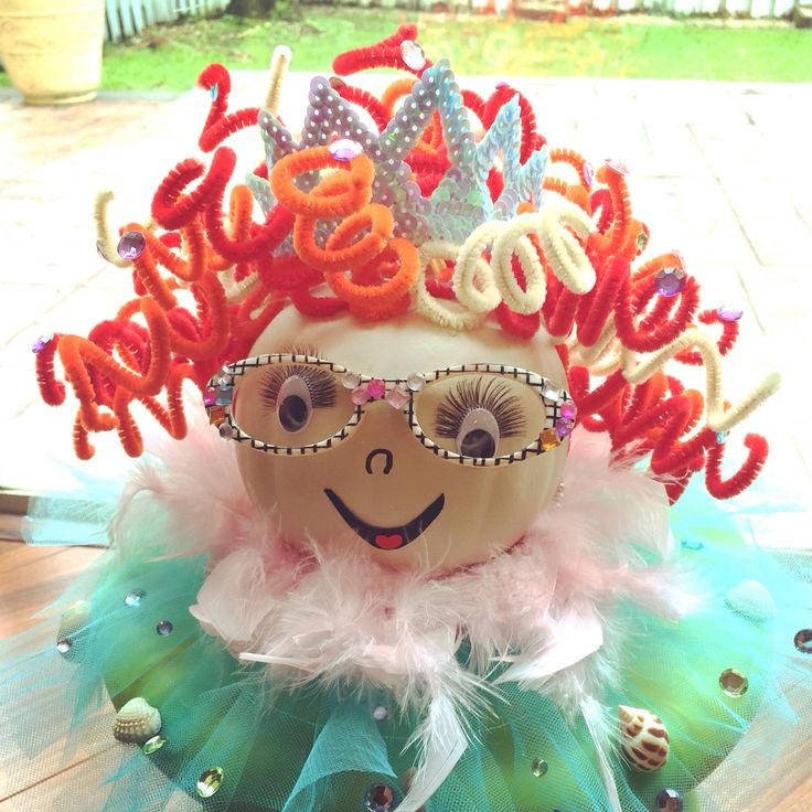 an egg wearing a tiara and glasses on top of a table