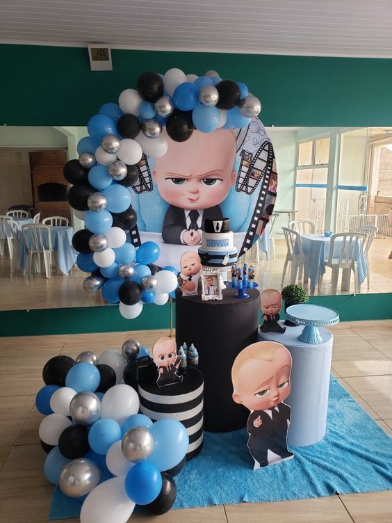 a table with balloons and decorations for a baby's first birthday