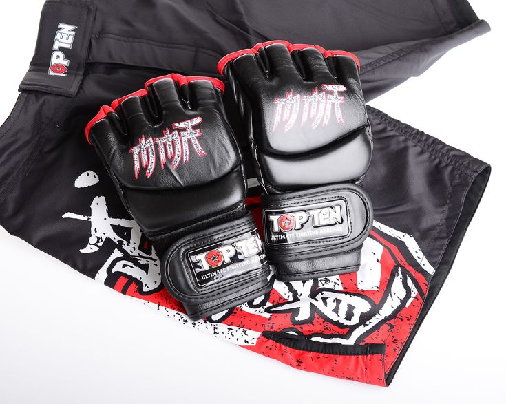 two black and red gloves sitting on top of a bag