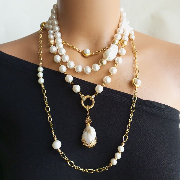 Treat yourself to the incomparable beauty of this exquisite Pearl Necklace. This layered baroque statement natural stone jewelry is delicately handmade to perfection, making it the perfect accessory for any occasion. Whether you are dressing up for a wedding, standing at the ready as a bridesmaid or looking for a special bridal gift, this Gold Filled Chain Necklace is sure to create a unique sentiment. DIMENSIONS: Inner row necklace 42 cm. Outer row necklace 47 cm. Chain necklace 104 cm. Mayorka Pearl Necklace Handmade, Akoya Pearl Necklace, Pearl Beaded Necklace, Necklace Layered, Gift For Wedding, Baroque Pearl Necklace, Gold Pearl Necklace, Natural Stone Jewelry, Necklace Wedding