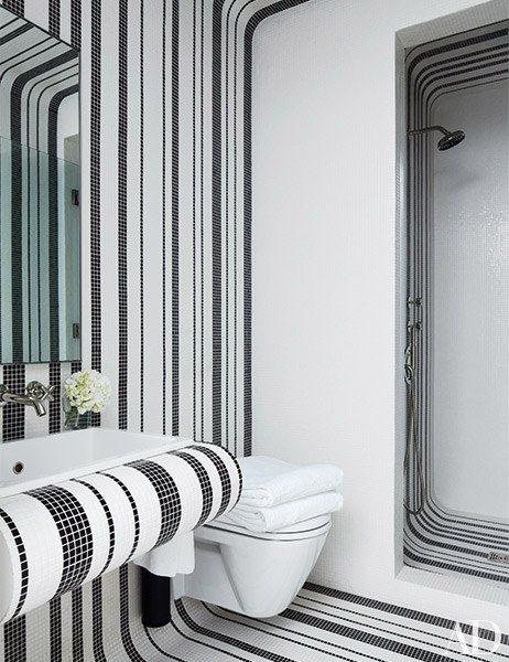 a bathroom with black and white stripes on the walls