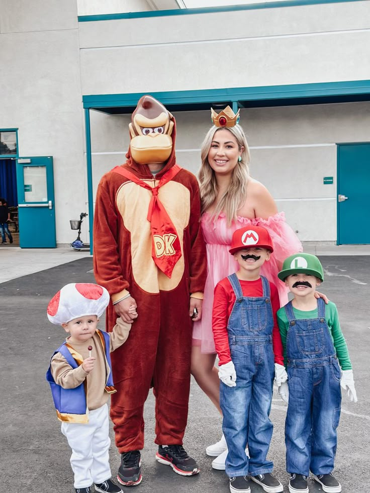 a woman and two children are dressed up in costumes