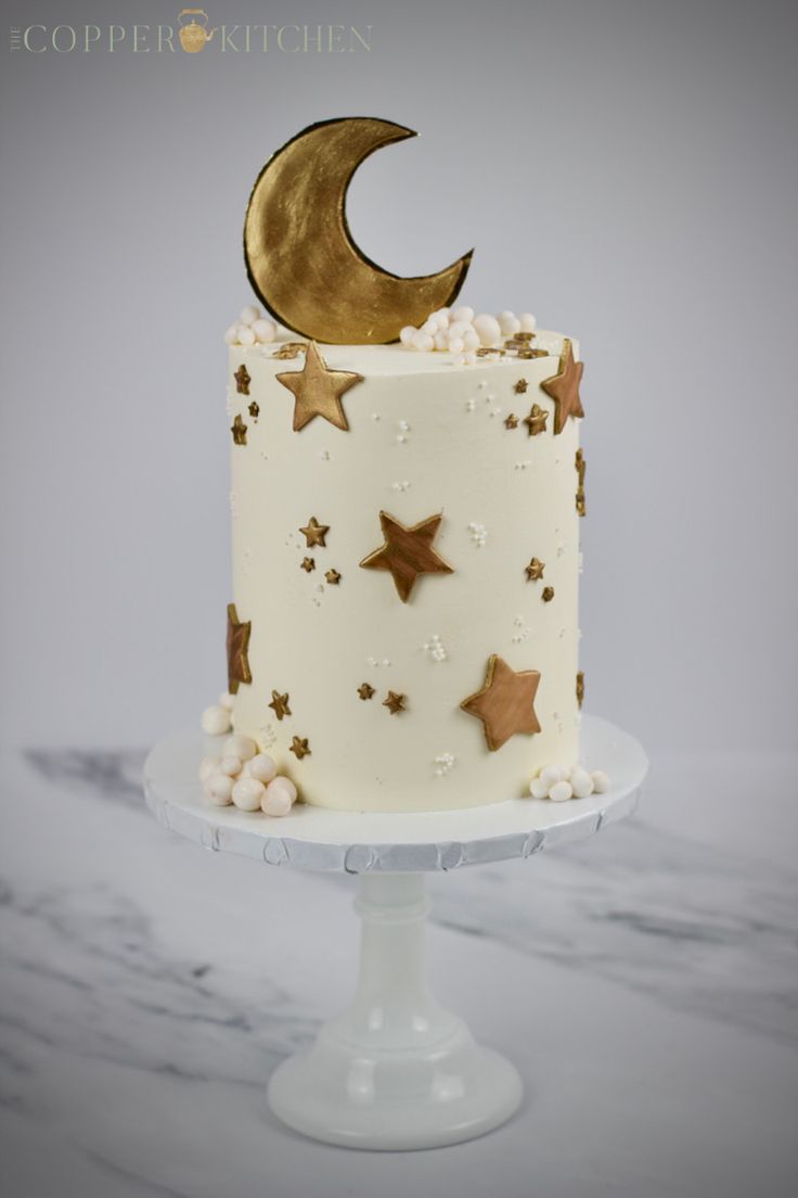 a white cake with gold stars and a crescent on top