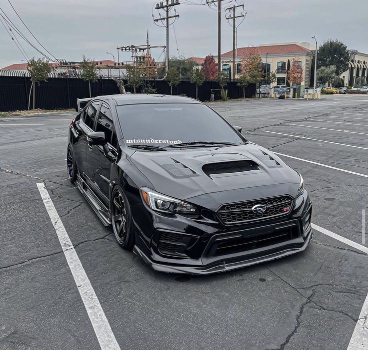 a black car parked in a parking lot