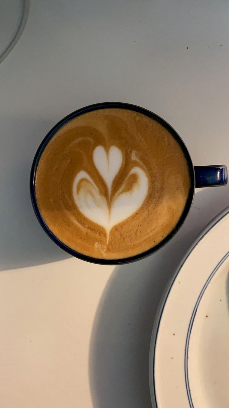 a cappuccino with a heart in the foam