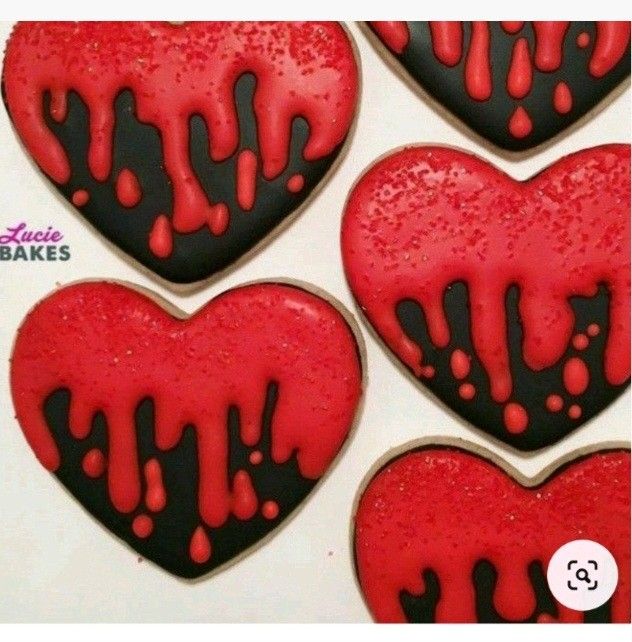 heart shaped cookies with red and black icing