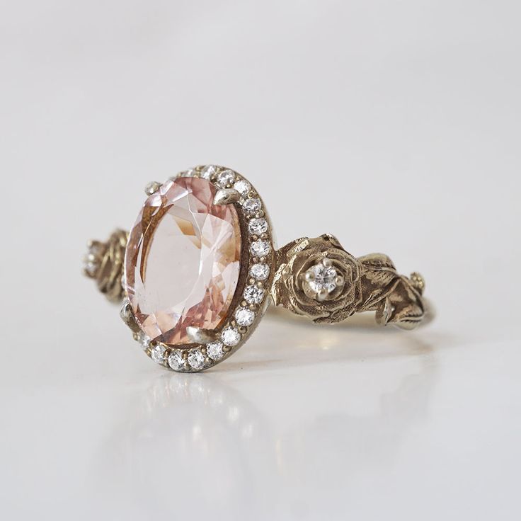 "Captivating Morganite Rose Ring: A Timeless Treasure" Fall in love with our Morganite Rose Ring, adorned with its soft and enchanting peachy pink hue that's sure to capture your heart. This dreamy piece is expertly set in your choice of 14K or 18K gold, enhancing its timeless allure. The sculpted roses that grace this ring elevate its beauty, adding a touch of artistry to an already exquisite design. The low-profile setting ensures that the gem gently rests against your skin, creating a spiritu Luxury Pink Halo Ring For Wedding, Exquisite Morganite Rose Gold Rings, Exquisite Rose Gold Morganite Ring, Delicate Pink Rings With Rose Cut Diamonds, Elegant Blush Ring With Center Stone, Exquisite Pink Morganite Ring, Luxury Pink Rose Cut Diamond Wedding Jewelry, Elegant Pink Halo Ring For Anniversary, Delicate Pink Jewelry With Rose Cut Diamonds